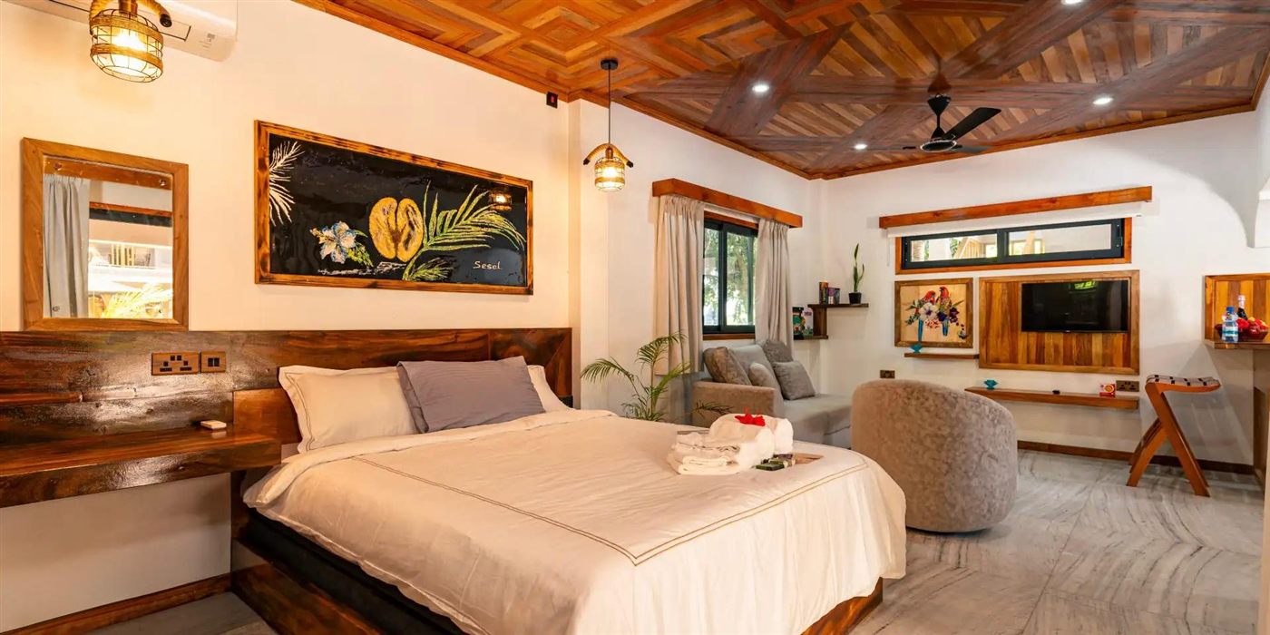 A room at AliBel with a handmade coffered timber ceiling and Salifa's own paintings