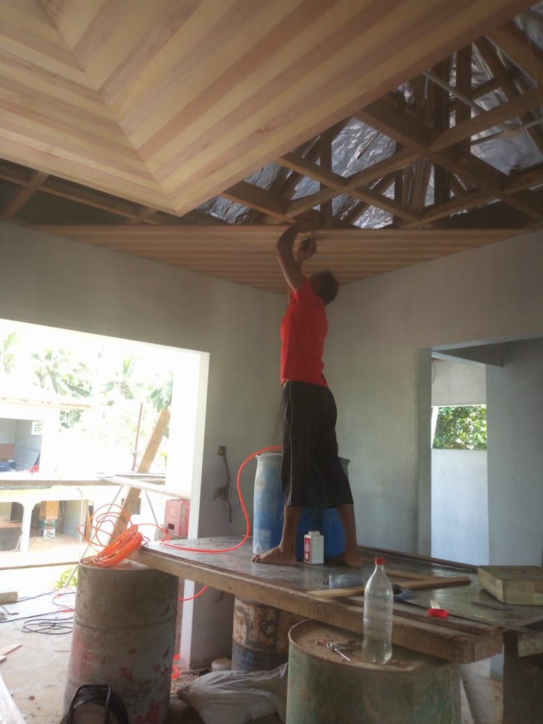 Fitting the timber ceiling by hand during the build