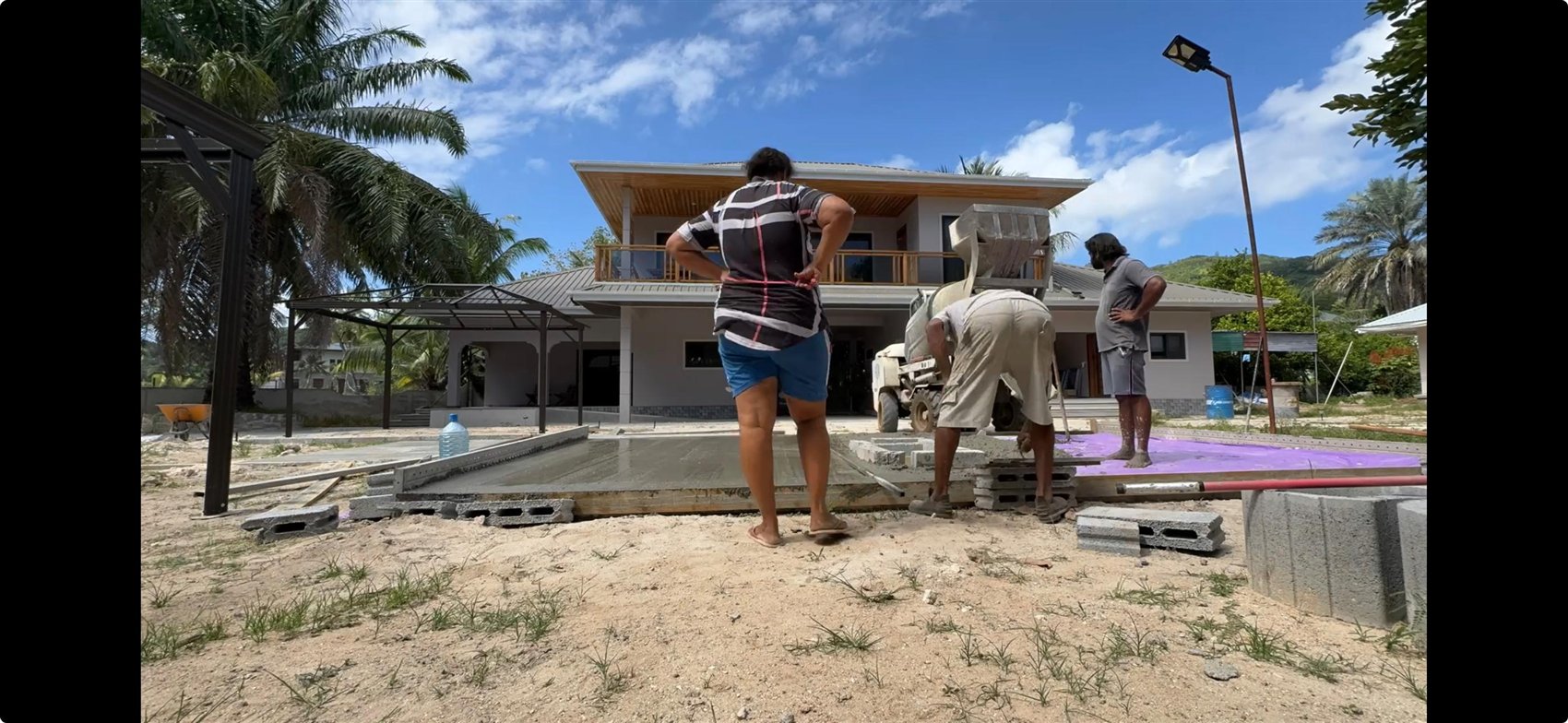 Salifa and the team laying the slab, building Alibel by hand